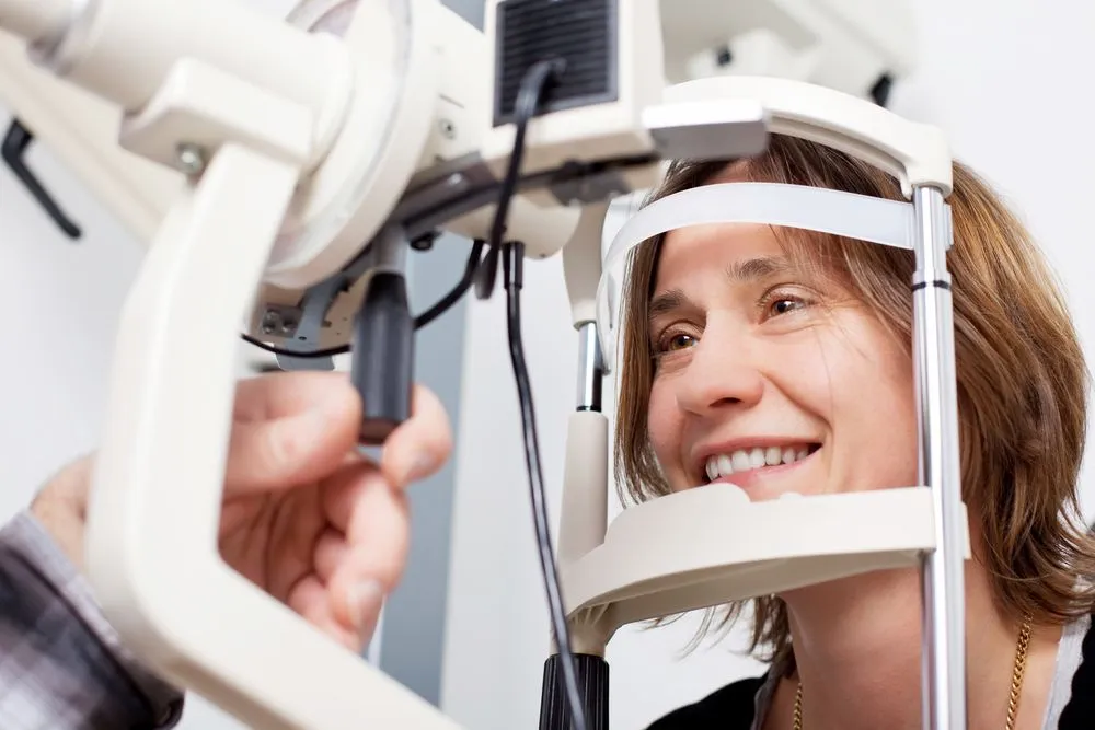 woman receiving an eye exam from her local optometrist