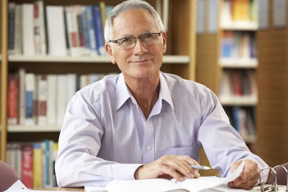 man with glasses in the library