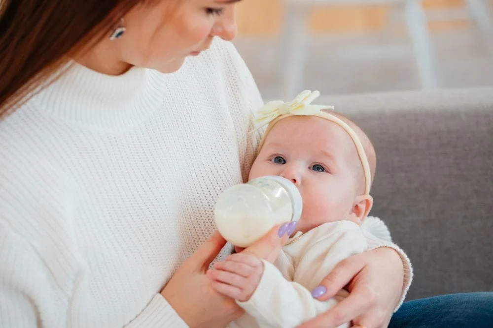 Infant Drinking Milk From Bottle
