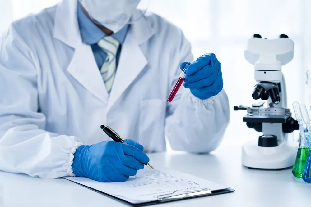 Doctor examining blood vial