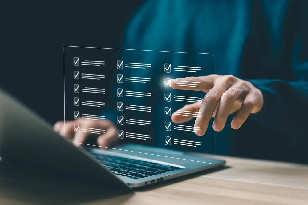 Model of virtual list from a laptop with person touching the checklist