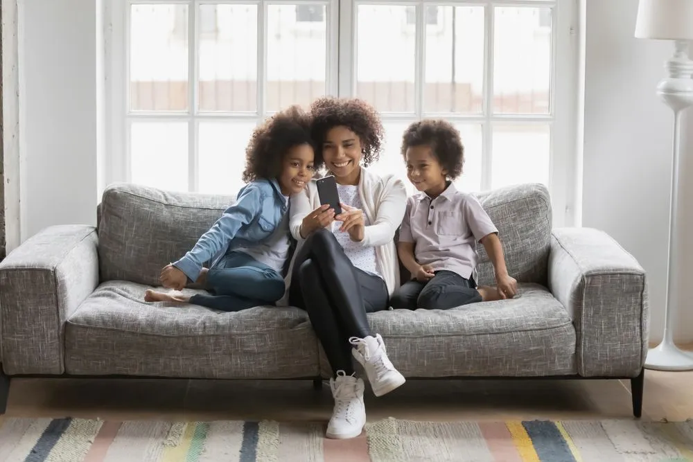 Family Smiling on Couch