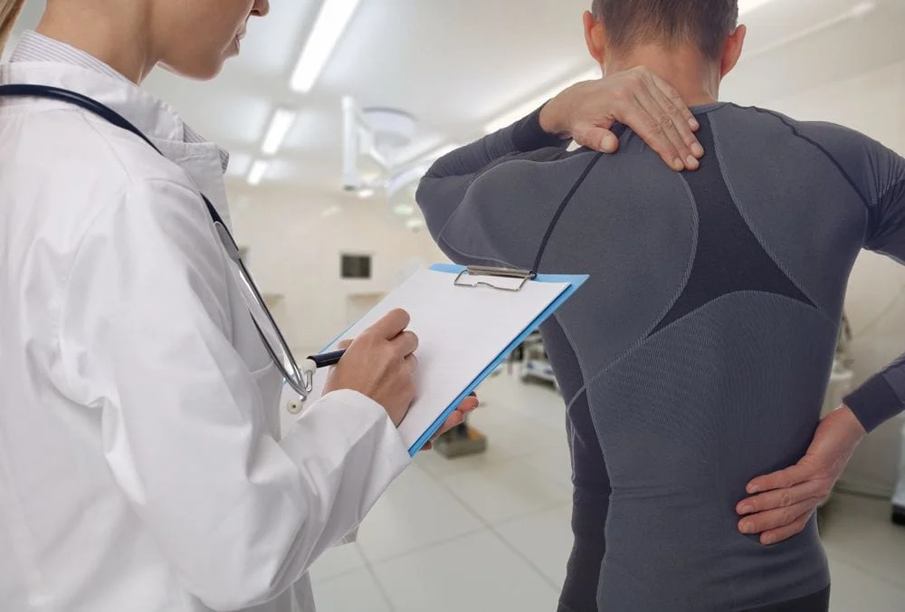 chiropractor and patient with back pain getting treated