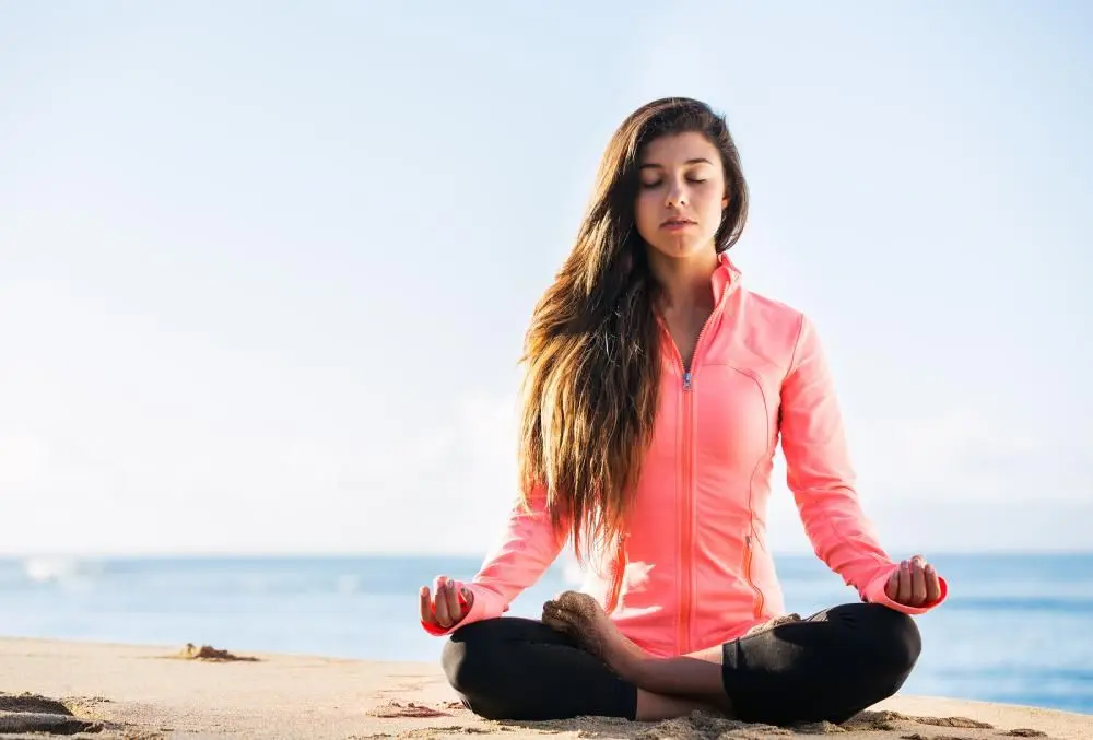 Woman meditating at the beach in Bradenton, FL 