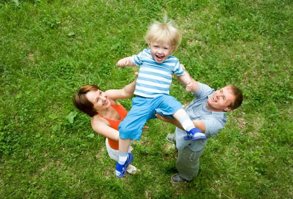 parents throwing kid in the air