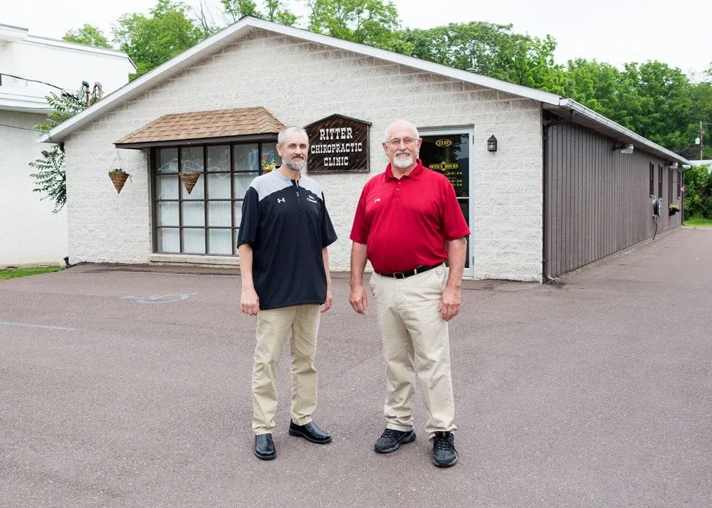 doctors matt ritter and earl ritter in front of their clinic