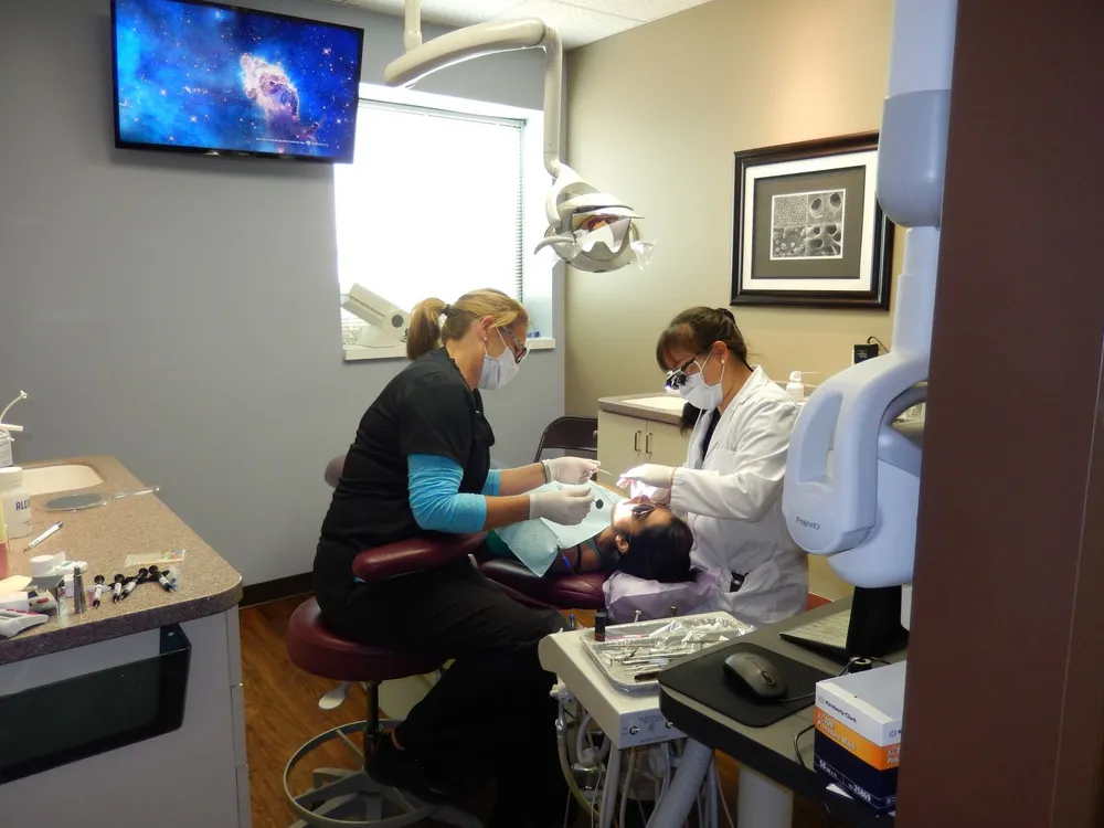 Dr Stringer and Susan cutting a crown for a patient