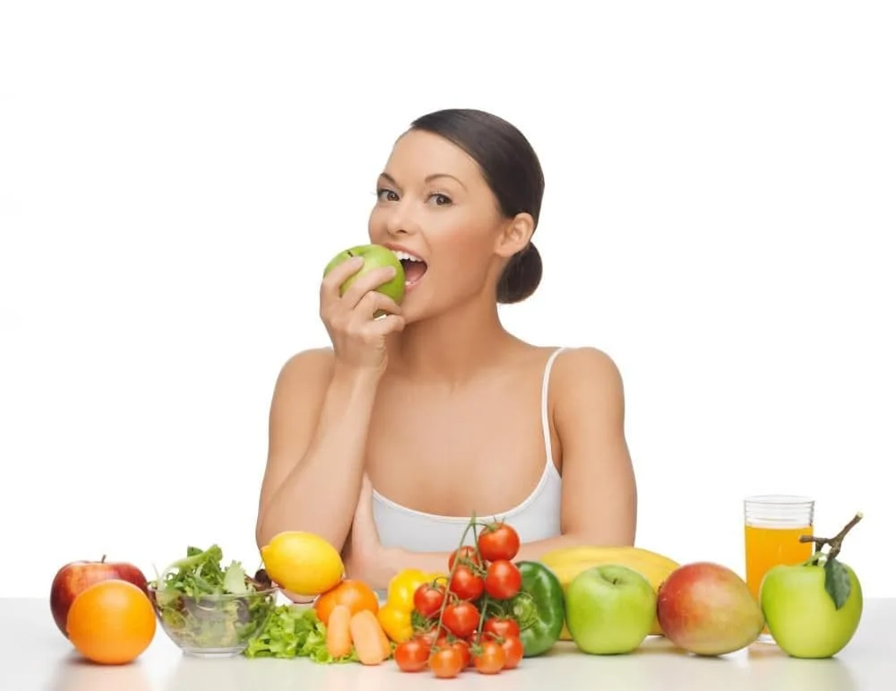 woman eating fruit and vegetables