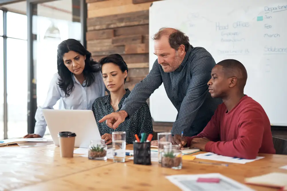 person coaching group of workers