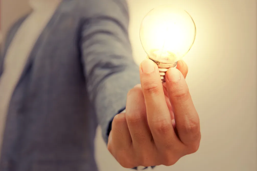 Person holding lightbulb