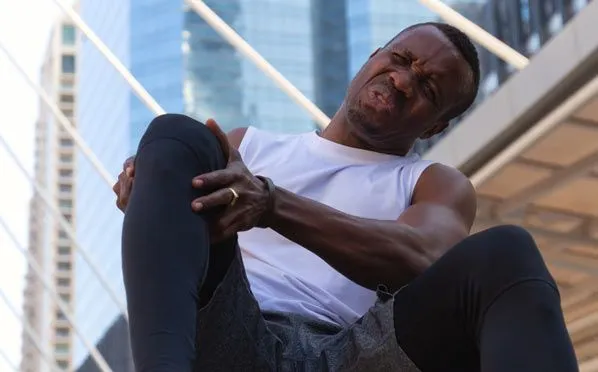 man holding his sore knee