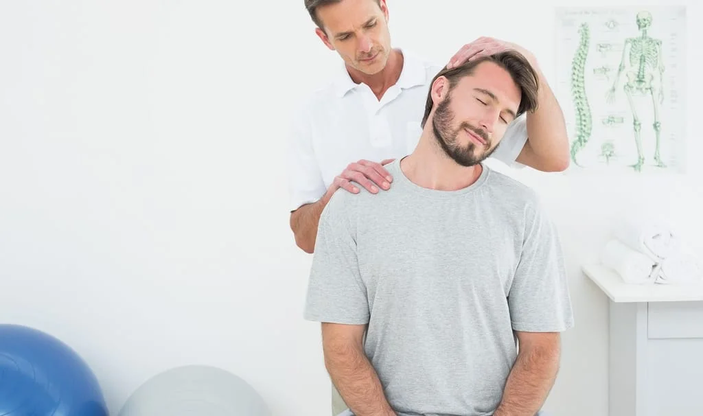 chiropractor adjusting patients spine