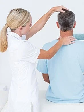 female chiropractor evaluating the neck of a patient