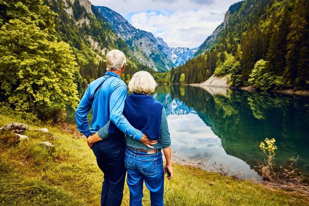 Couple overlooking scenic water and mountain view
