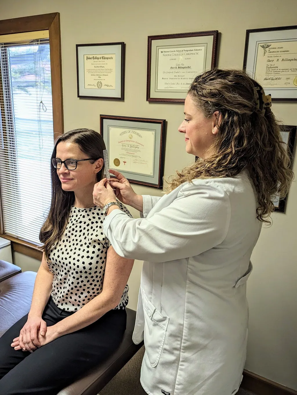 Doctor Pavnica performing chiropractic exam including posture and nerve testing