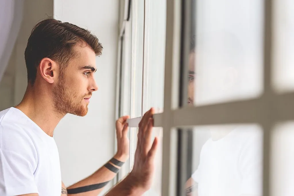 A man looking through a window