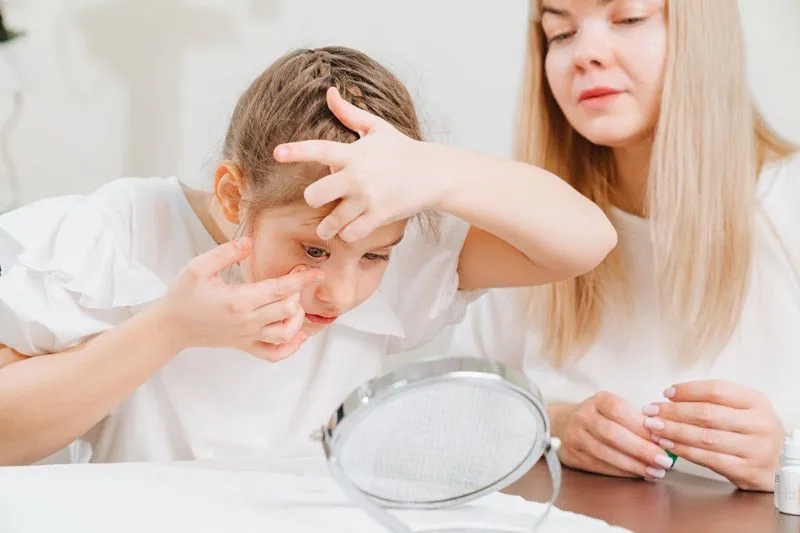 young girl inserting contacts