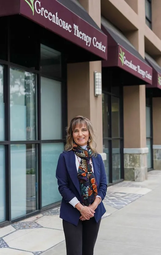 Our director standing in front of our suite with our awnings and our name showing behind.