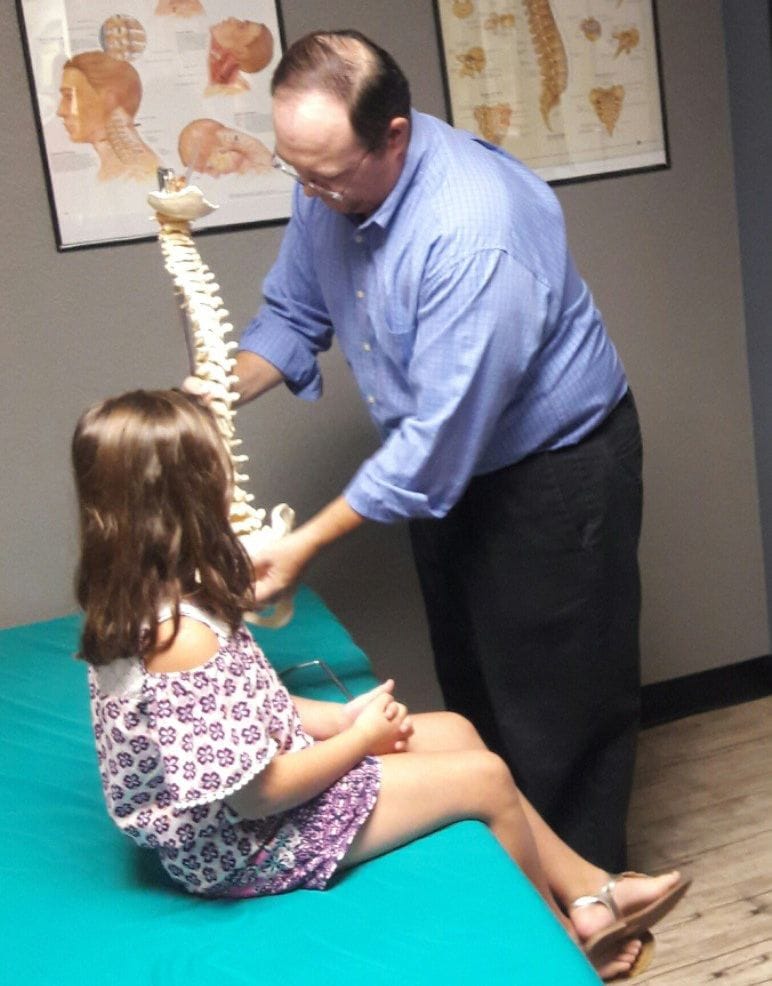 doctor showing patient spine