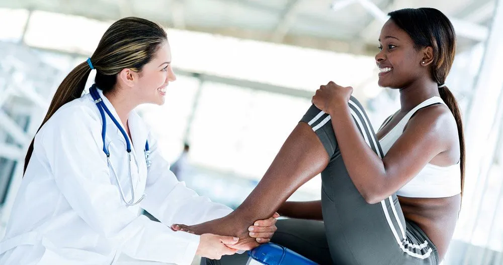 A doctor holding a woman's feet