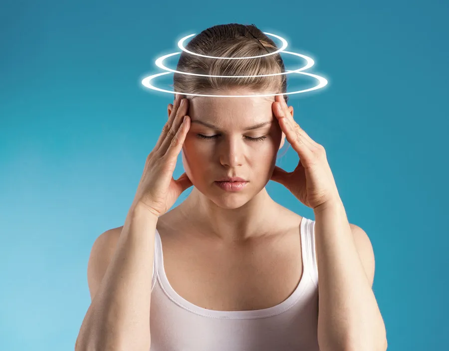 A woman with her fingers on her temples. Three rings of light are eminating from her head indicating pain.