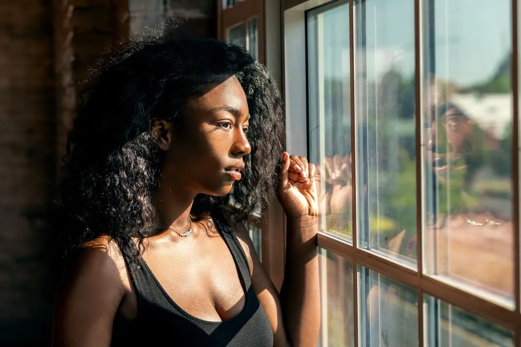 woman looking out window