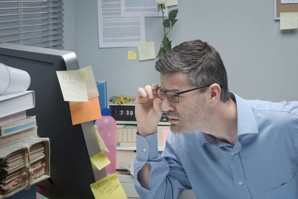 Man having hard time to read 