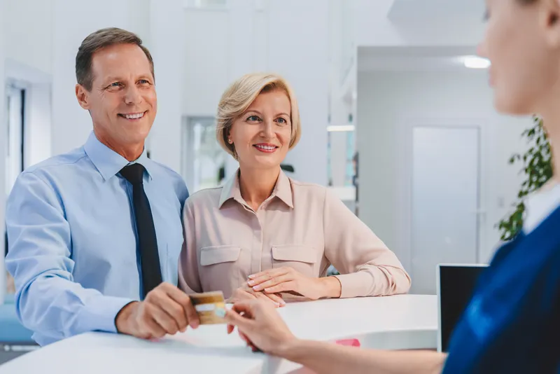 couple making a payment after services
