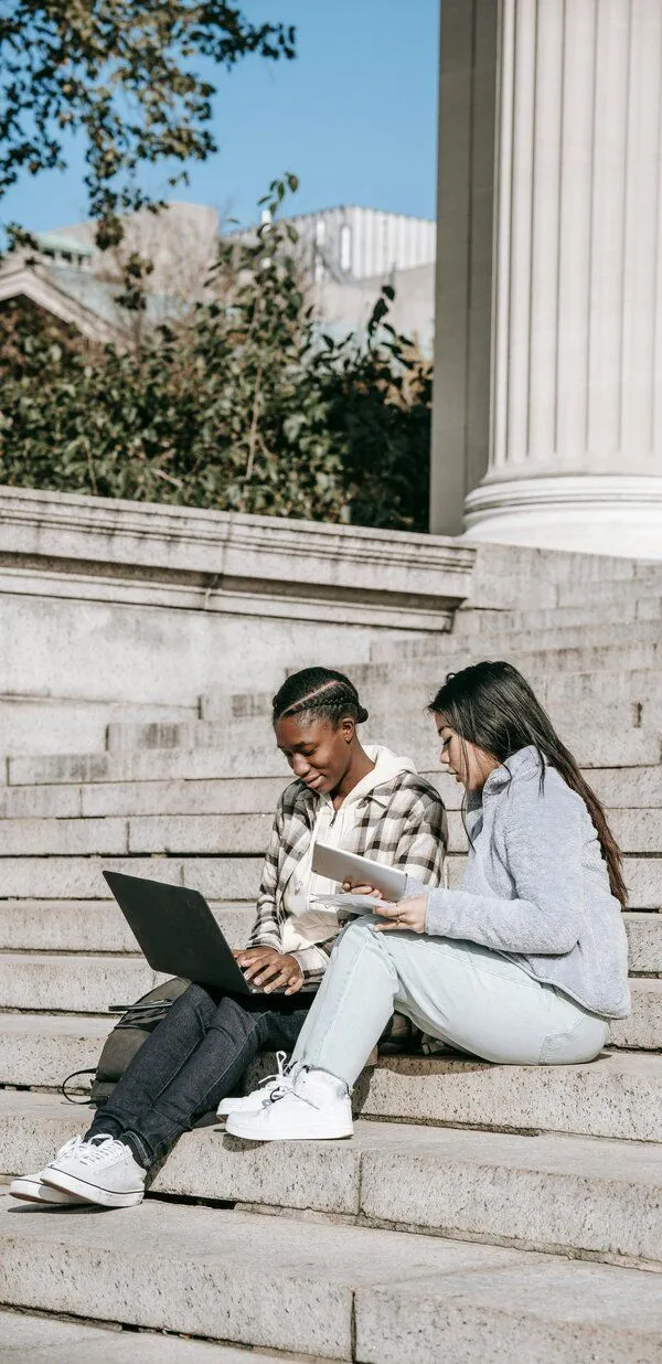 two people sitting looking at a computer