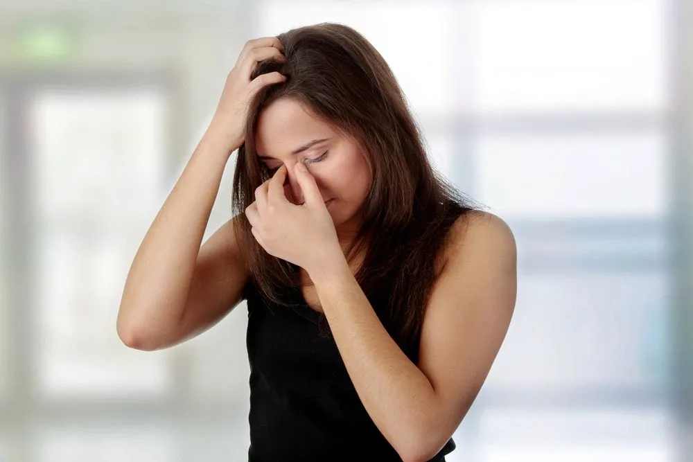 A woman holding her nose