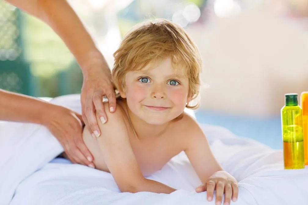 kid smiling while having a massage