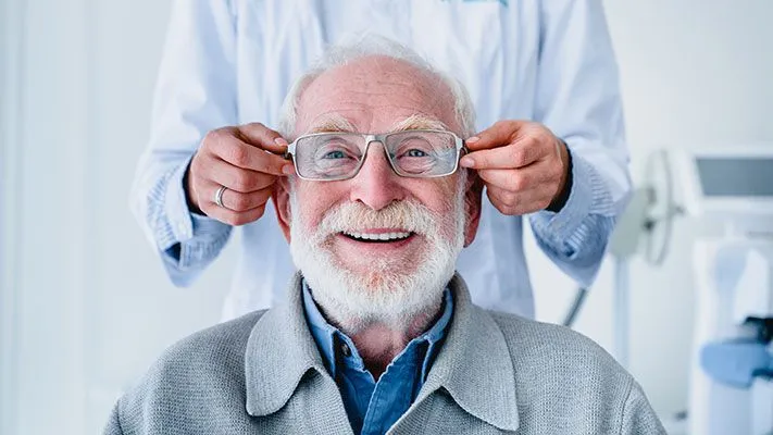 man trying on glasses