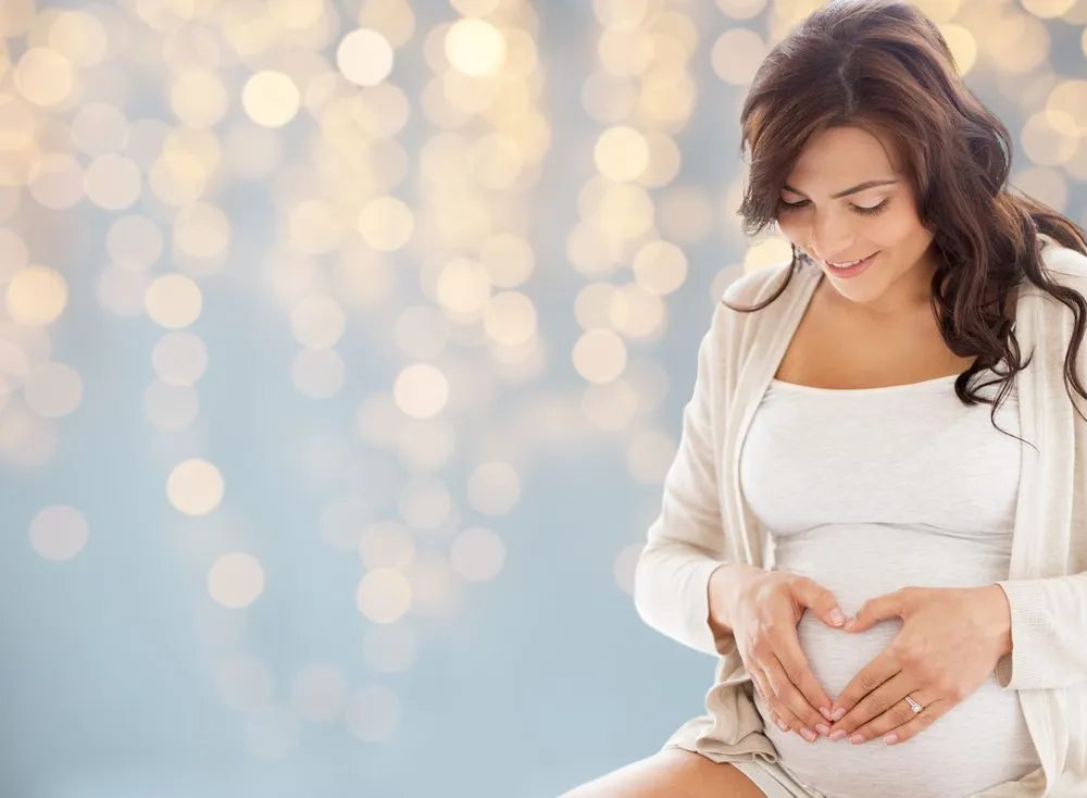 pregnant woman holding stomach