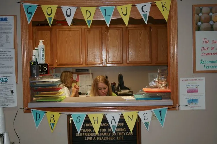 Image of frond desk with a banner that reads goodluck dr shane