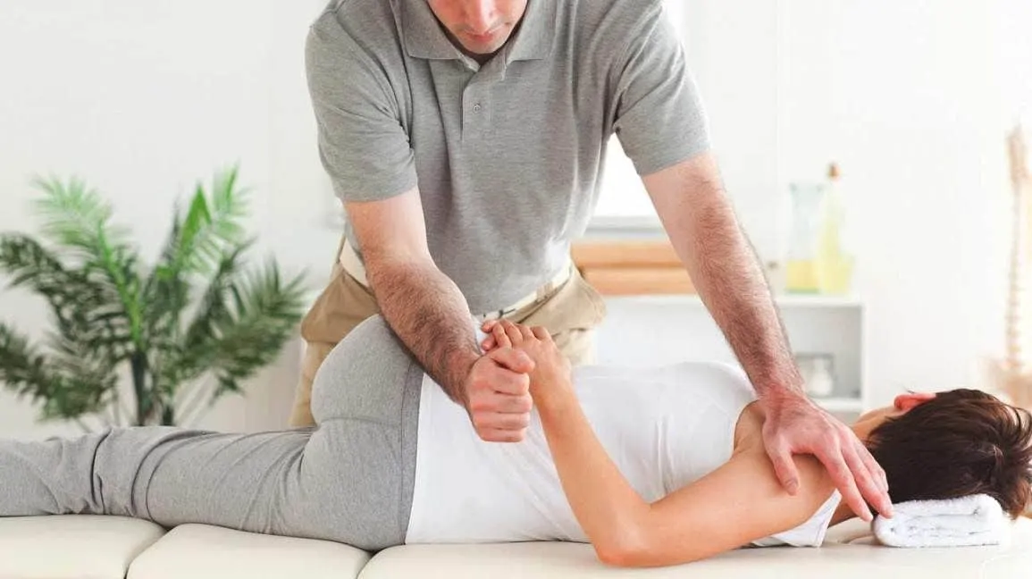 man/woman getting exam from chiropractor
