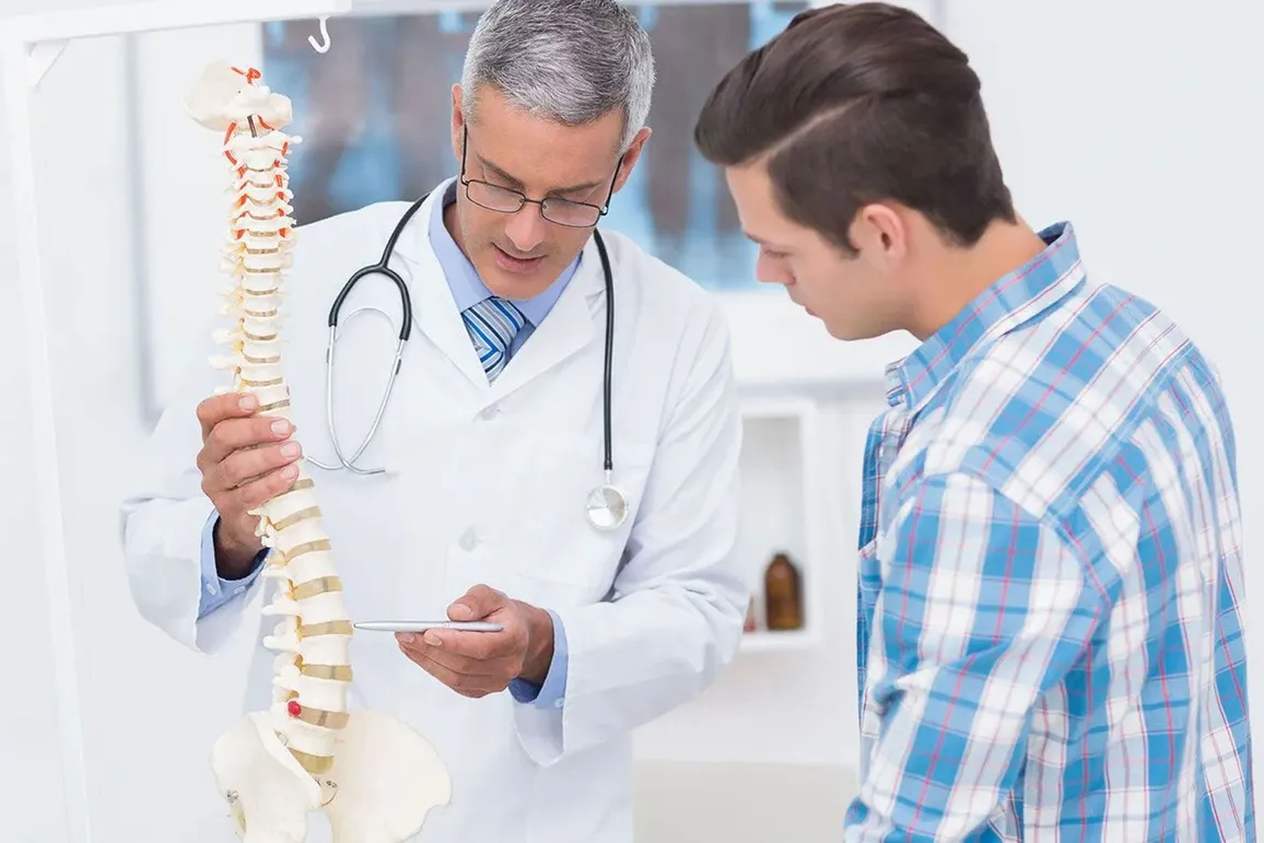 doctor showing spine model to a patient