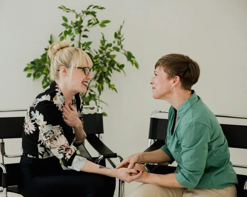 two people sitting and talking
