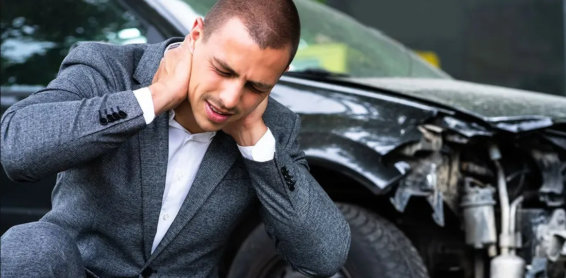 man holding his neck following an auto accident