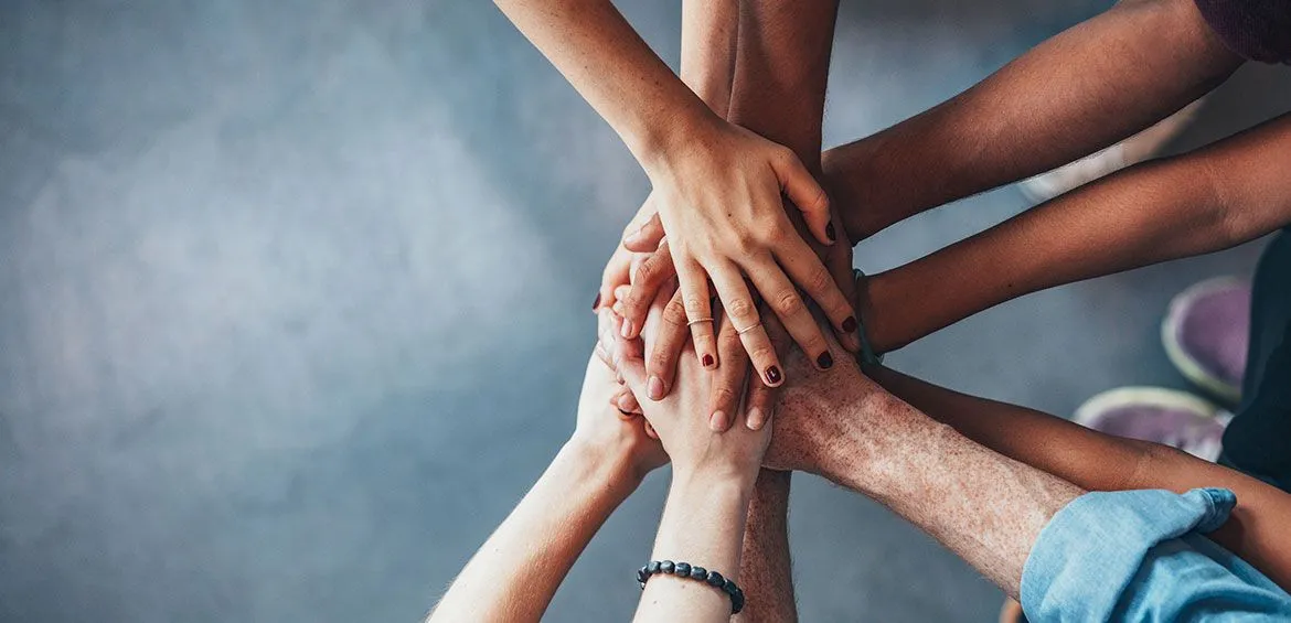 Group of people holding hands