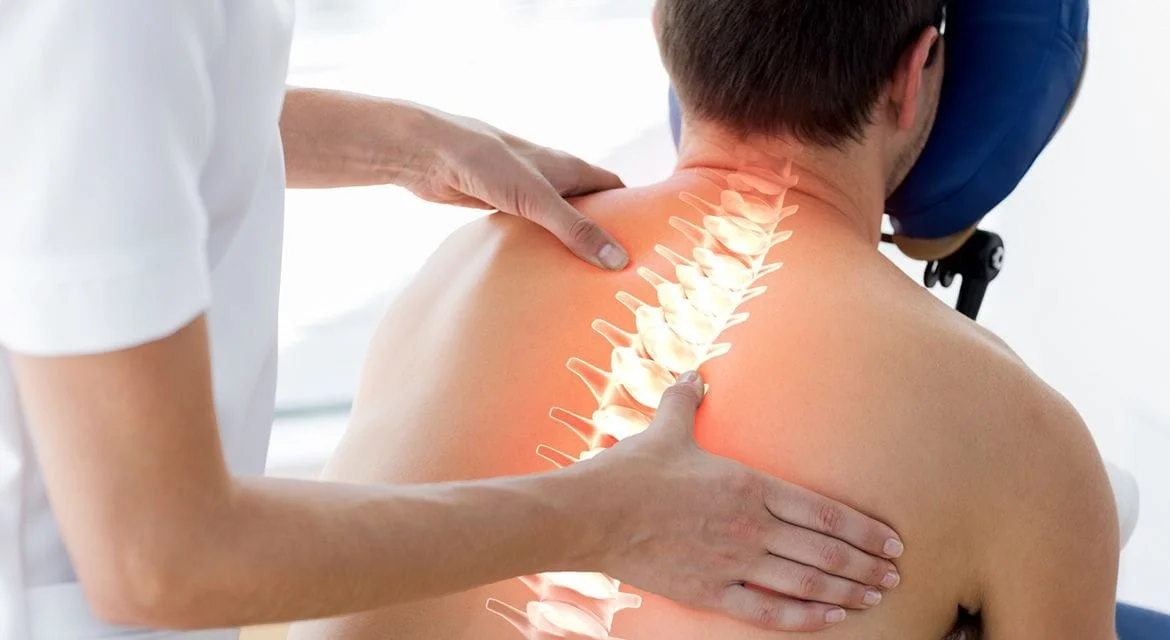 Chiropractor adjusting patient with illuminated spine