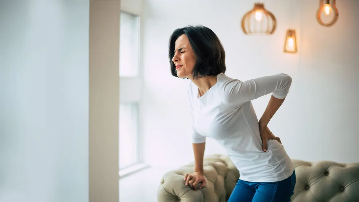 Woman bending over with low back pain
