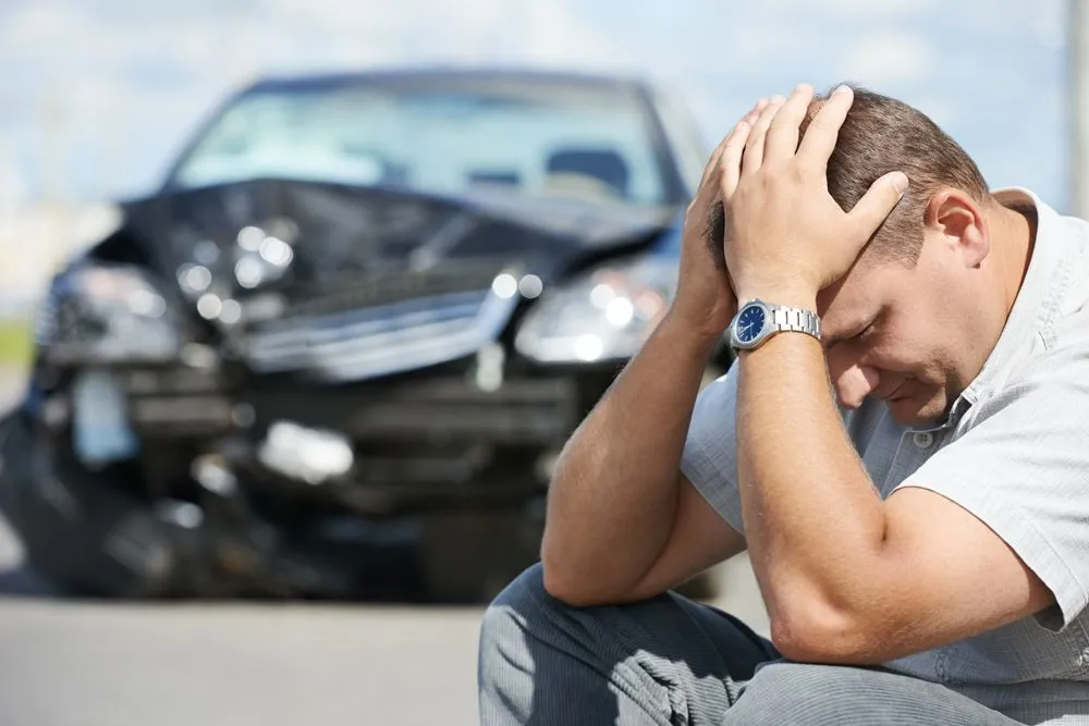 man holding his head after an auto accident