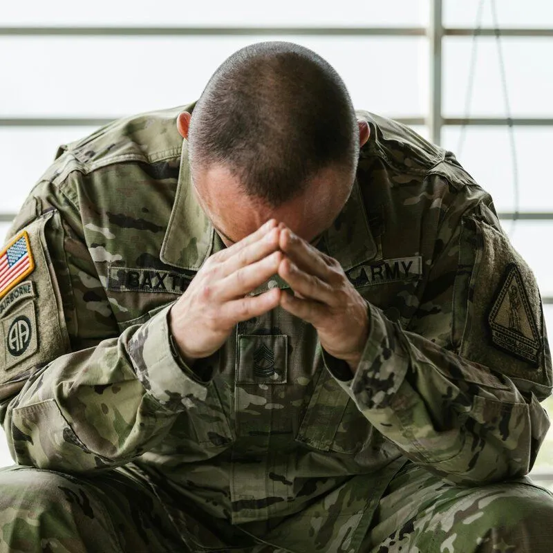 person sitting with head in hands