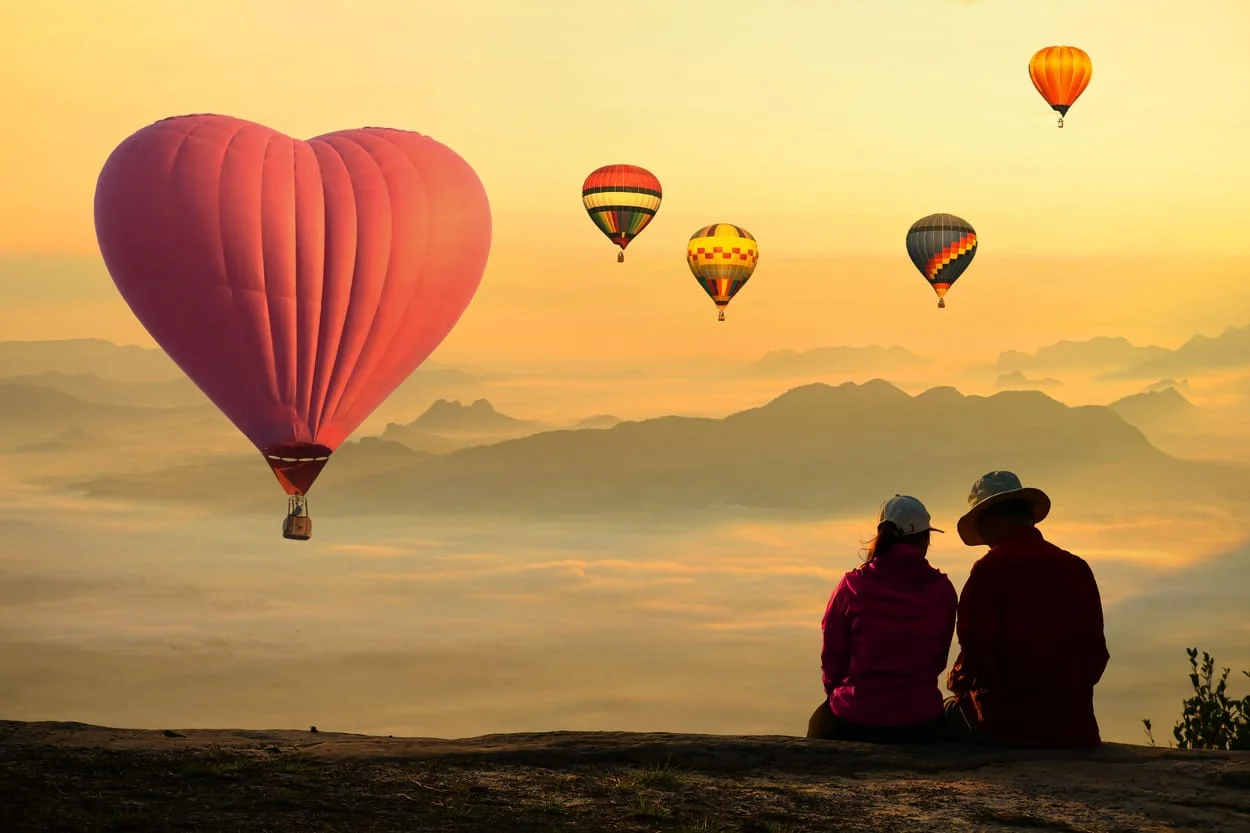 Couples Watching Hot Air Balloons at Sunset