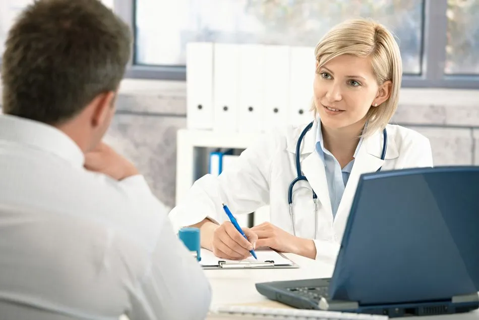 A doctor listening to a patient and writing on a clipboard