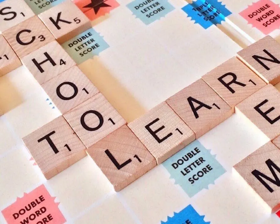 scrabble tiles spelling out school and learn