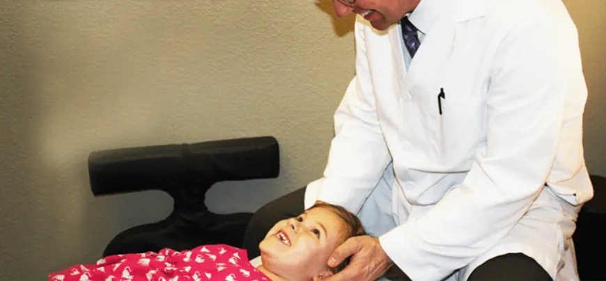 Dr. Bartlett Adjusting a Child