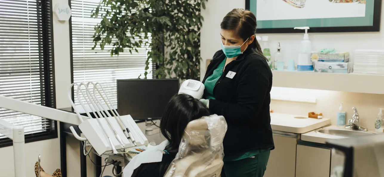 Registered Dental Assistant, Rosie taking x-ray images on a patient in the Crockett Dental Care office.