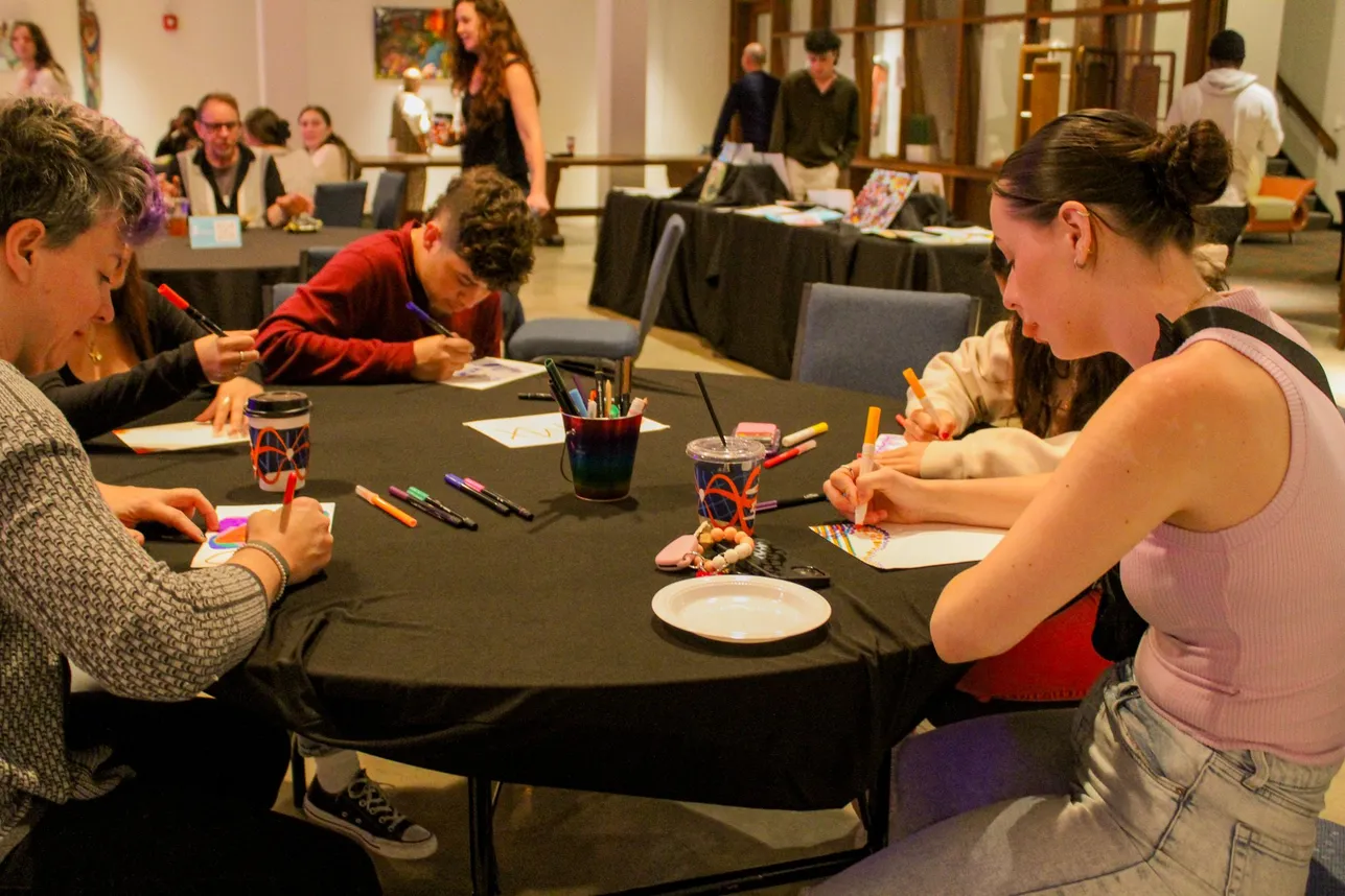 people drawing at a table