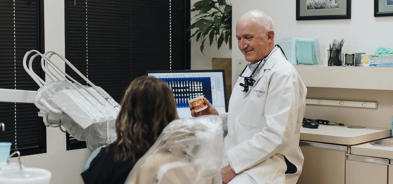 Dr. Holcomb conversing with a patient in an operatory at the Crockett Dental Care office.